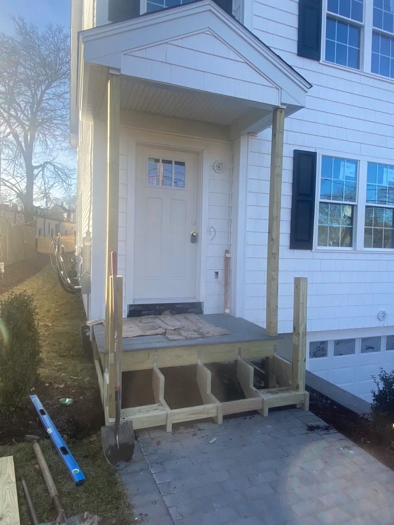 White entry portico with columns and a front door